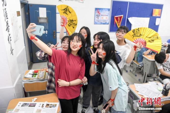 資料圖：6月6日，2021年高考前夕，湖南長(zhǎng)沙同升湖實(shí)驗(yàn)學(xué)校高三年級(jí)，考生們?cè)诮淌覂?nèi)合影。 楊華峰 攝